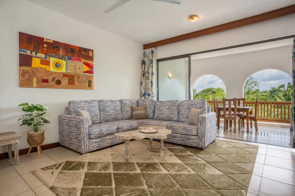 Tulia living room opening onto a private balcony with tropical views